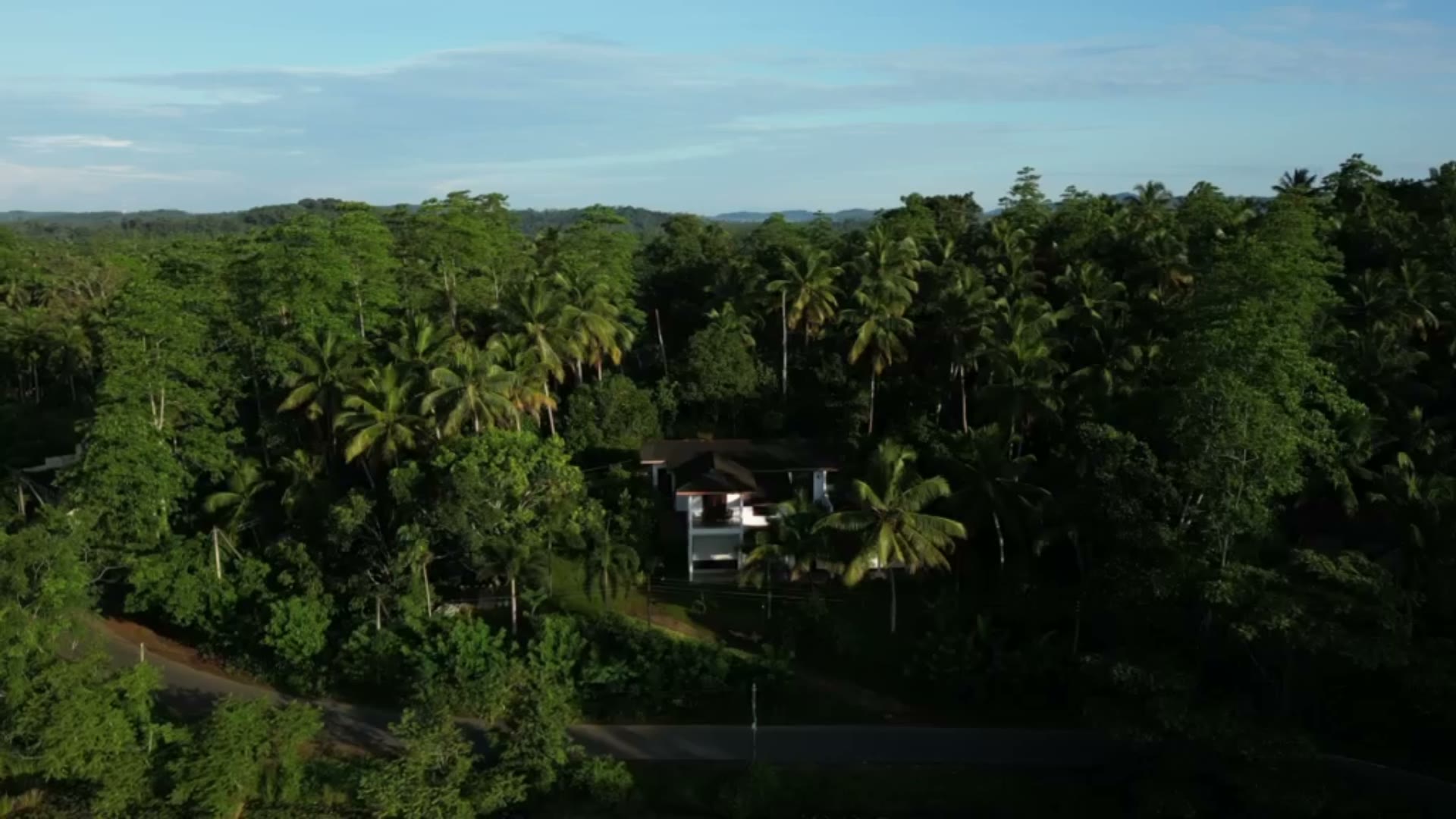 Aerial drone view of an Artios-managed villa nestled in tropical forest