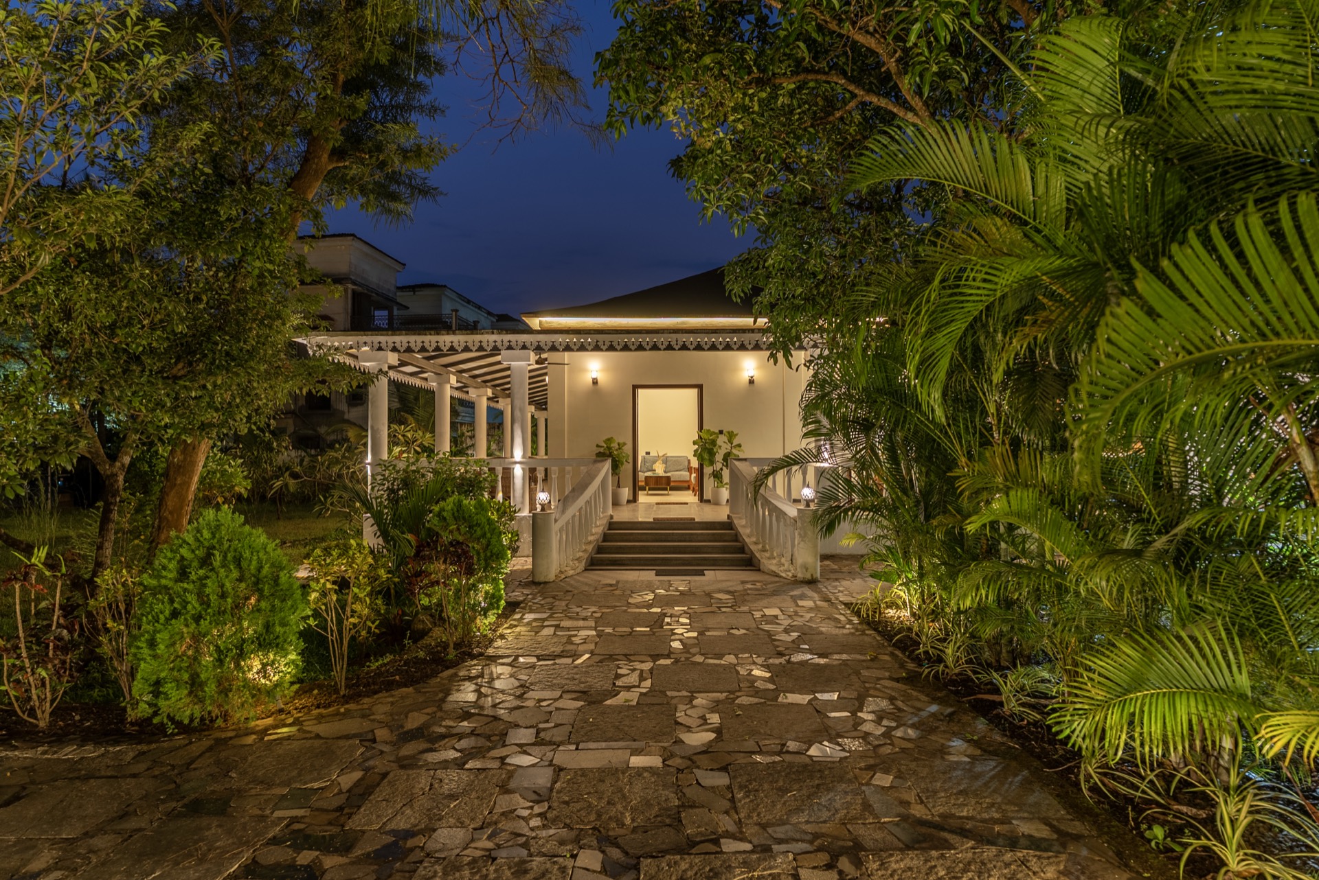 Illuminated entrance walkway of an Artios-managed villa at night